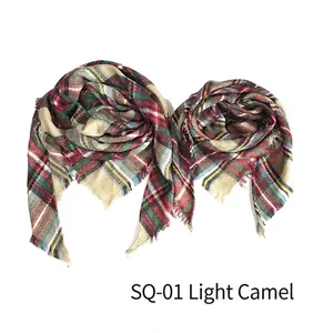 Detail of light camel plaid scarf showing soft cashmere-like texture and frayed edges