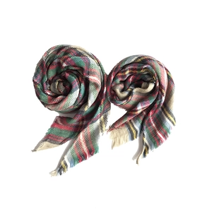 Detail of classic plaid cashmere-like scarves with fringe edges in vibrant colors