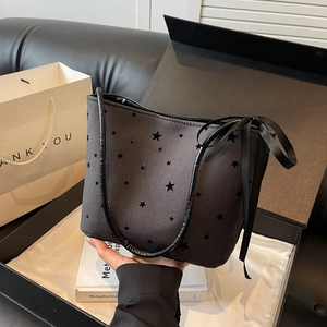 Dark grey canvas tote bag with black star prints and a satin bow charm detail