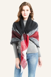 Close-up of fringe edges and red-black-grey plaid pattern on thick winter scarf