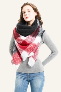 Detail of red and white plaid knit scarf with soft cashmere-like texture and fringed edges