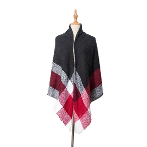 Detail of checkered shawl with fringe edges in black red and white plaid pattern