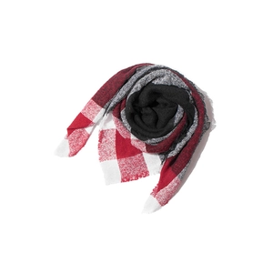 Detail showing the red and black plaid pattern and soft fringed edges of a knit scarf