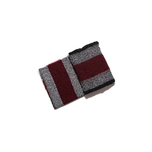 Detail view of burgundy and grey plaid scarf featuring soft knit fabric and fringe edges