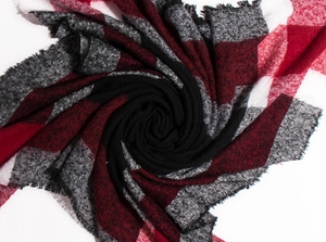 Macro detail of red and grey plaid scarf texture with knitted fringe edges