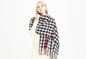 Close-up of classic red and black buffalo plaid scarf with soft tassel trim details