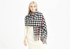 Close-up of black and white checkered scarf with red accents and fine tassels