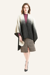 Detail of gradient black and white cashmere-like shawl with edge stitching and split hem