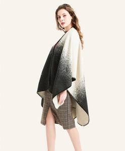 Detail view of black and white gradient knit shawl with fine edge stitching and soft texture
