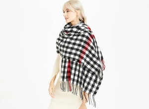 Close-up of soft cashmere-feel scarf with black and white plaid pattern and fringes