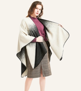 Detail of black and white gradient shawl featuring bold stitched edges and dot patterns