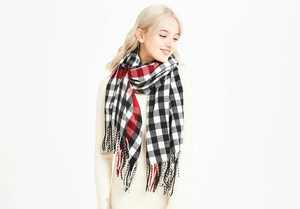 Detail shot of the red and black buffalo plaid tassel edges on a warm winter scarf