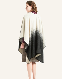 Detail view of black and white gradient cashmere-like shawl with dense overlock edges
