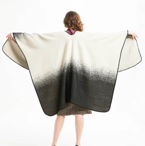 Detail of black and white gradient shawl featuring professional overlock edge stitching