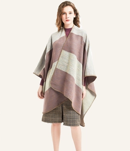 Detail of multi-color striped knit poncho with professional stitching and soft texture