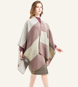 Detail of knit striped poncho showing fine stitching and soft ombre texture