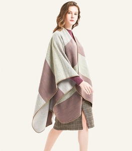 Detailed view of striped knit shawl with hand-stitched edges and elegant color blocks