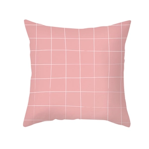 Detailed close-up of pink peach skin pillow cover with white grid texture patterns