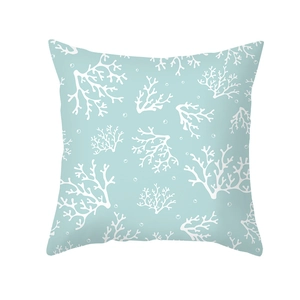 Detailed view of blue pillowcase featuring white coral patterns and soft peach skin texture