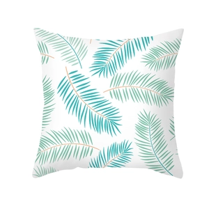 Close-up of blue tropical palm leaf print on a white decorative square pillowcase