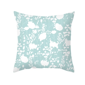 Detail of blue geometric cushion cover with white floral print on soft peach skin fabric