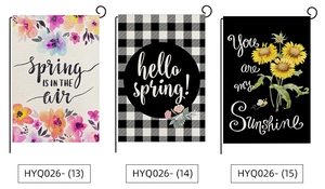 Detailed view of three polyester garden flags featuring spring floral and sunflower designs