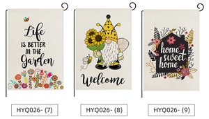 Three outdoor garden flags with floral gnomes and sweet home quotes on black metal stands