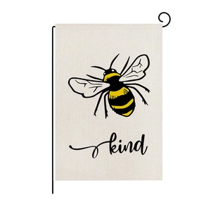 Polyester garden flag with watercolor bee design and Bee Kind text on black metal stand
