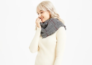 Detail view of houndstooth scarf with fine red stripes and soft fringe trim
