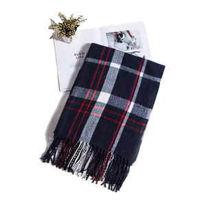 Detailed view of dark blue plaid scarf with fringes and colorful checkered pattern