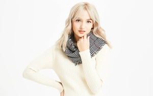 Detailed view of autumn winter plaid scarf featuring soft texture and tassel edges