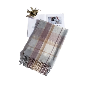 Detail of plaid scarf fringe with a soft texture in grey, purple, and beige colors