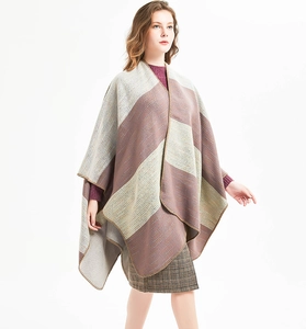 Detail of grey-green striped knit shawl featuring high-quality overlock stitching edge