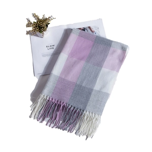Detail of plaid scarf featuring lavender and grey check pattern with fringe tassels