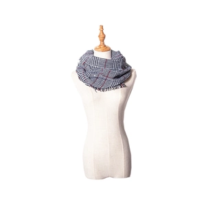 Detailed close-up of classic houndstooth plaid scarf with red and black fringe edge