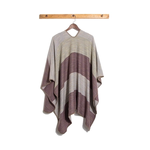 Detailed close-up of knit striped poncho showing fine lockstitch edges and texture