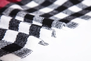 Close-up of soft plaid scarf fabric with classic buffalo check and woven texture