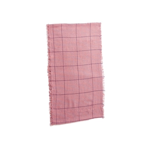 Detail view of pink plaid scarf with fringe edge and soft cashmere-like texture
