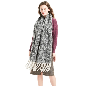 Thick chunky knit scarf in black and white mix with long fringe and braided texture
