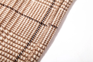 Macro view of Glen Check pattern on soft faux cashmere scarf with brown and khaki weave
