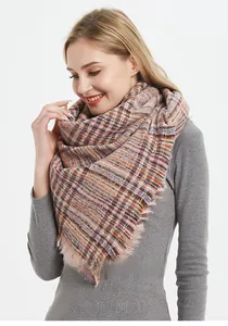 Detailed view of colorful checkered thick knit scarf with soft fringe trim texture