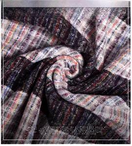 Macro view of thick checkered scarf fabric with a soft brushed texture and vibrant colorful yarns