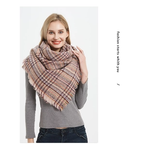 Detail of soft checkered scarf fabric showing thick texture and fine fringe edge