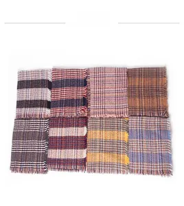 Macro detail of eight multi-colored checkered scarves with fringed edges and knit texture