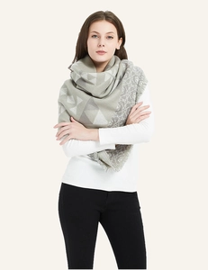 Close-up of geometric cashmere-feel scarf with elegant short fringe edges in grey and beige