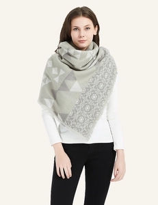 Detail of grey-green geometric and floral cashmere-like shawl with delicate fringe