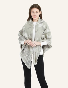 Close-up of geometric jacquard knit pattern and soft fringe on cashmere-like shawl