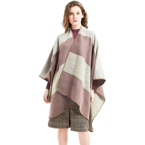 Women's autumn color-block striped poncho with fringe detail and soft knit texture