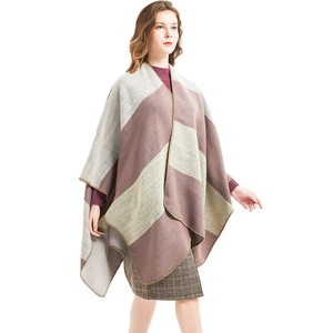 Striped knit poncho shawl in purple, light grey and green with overlock stitch finish