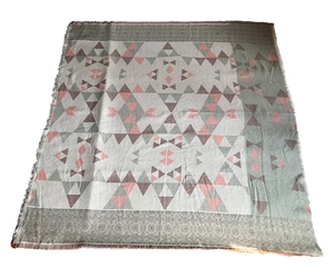 Close-up of geometric jacquard pattern and fringe detail on cashmere-like shawl